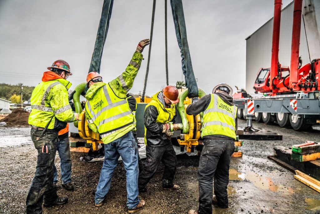 LGH shackles and slings being used for this lifting operation with men on job site. 