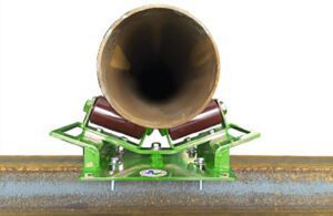 A green LGH rigging pipe roller, demonstrating how it moves a pipe.