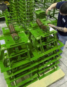 Multiple pipe rack rollers from LGH in a warehouse.