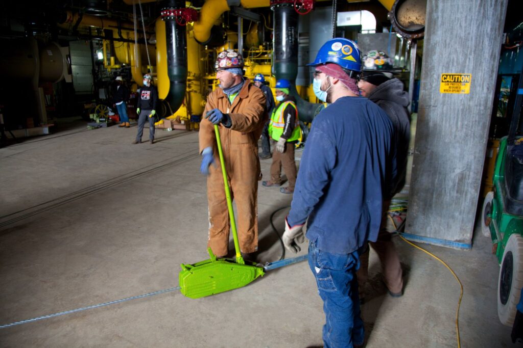 A Tirfor rental from LGH, aka a Griphoist, being used to move a chiller on an industrial jobsite in Chicago.