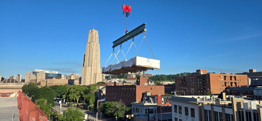 A curtain wall window crane pick, using LGH rigging including the multiple lug lifting beam and shackles