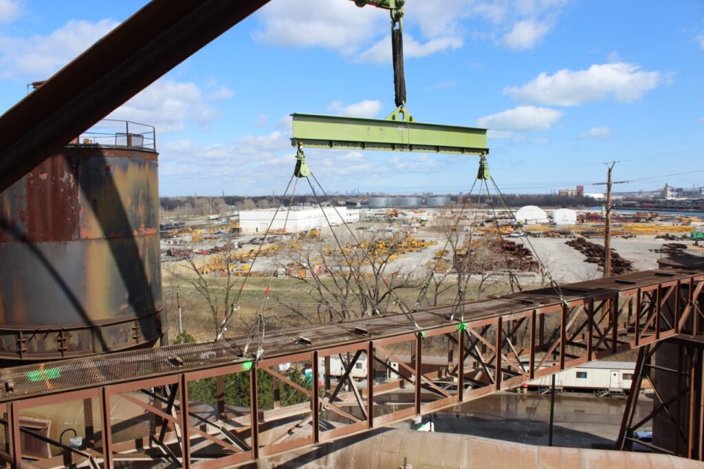 A low headroom lifting beam and rigging being used with a crane on a jobsite in Chicago