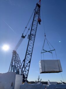 Aluex X-beam crane pick on jobsite blue sky