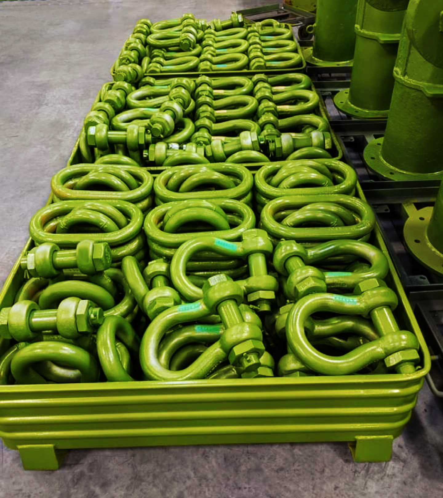 Warehouse photo of a shipping container full of green shackles from LGH.
