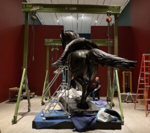 Gantry cranes used for statue installation at museum